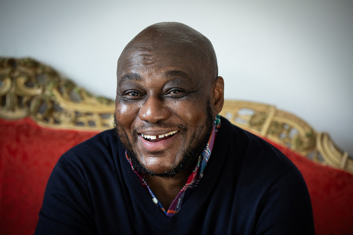 Criss Smith, an African American transgender man, poses for the camera in his New York apartment.